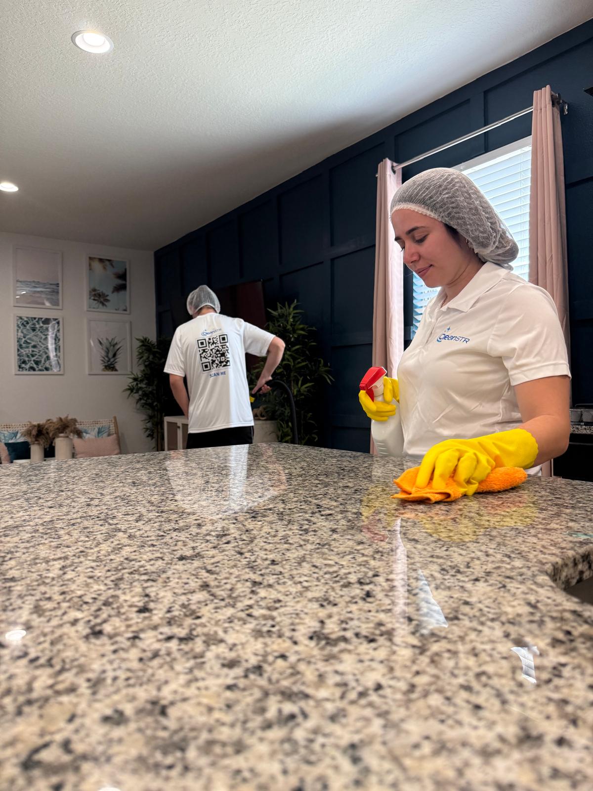 CleanSTR team polishing a granite kitchen countertop